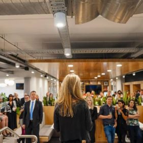 A person giving a speech in front of colleagues