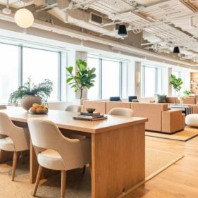 Bright breakout room with lounge and conference tables