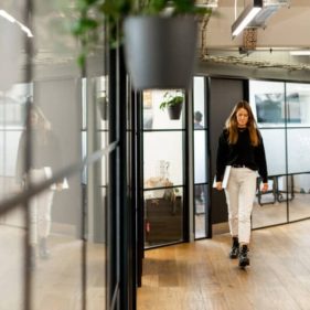 Modern office hallway with glass doors to private offices
