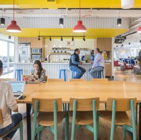 Office with large dining table and kitchen area